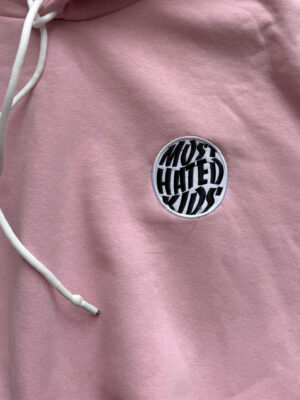 Close-up of the embroidered Most Hated Kids logo on the MHK Pink Hoodie.