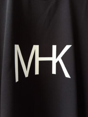 Close-up detail of the signature MHK logo graphic on the MHK Ultra Heavy Signature Black T-Shirt front design