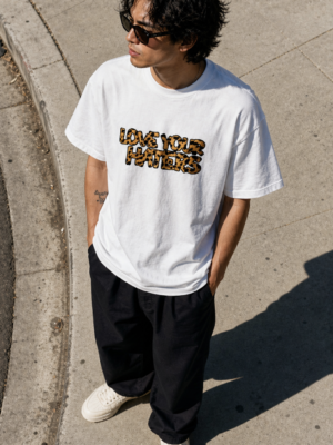 Model wearing Love Your Haters Leo White T-Shirt front view in lifestyle setting